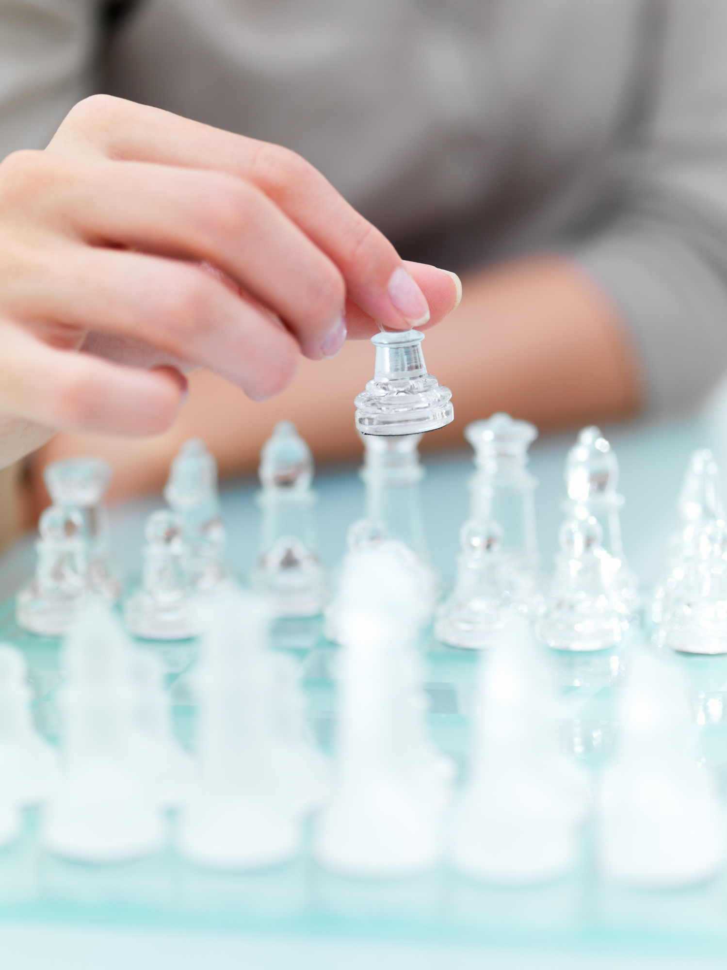Mid section view of a woman playing chess